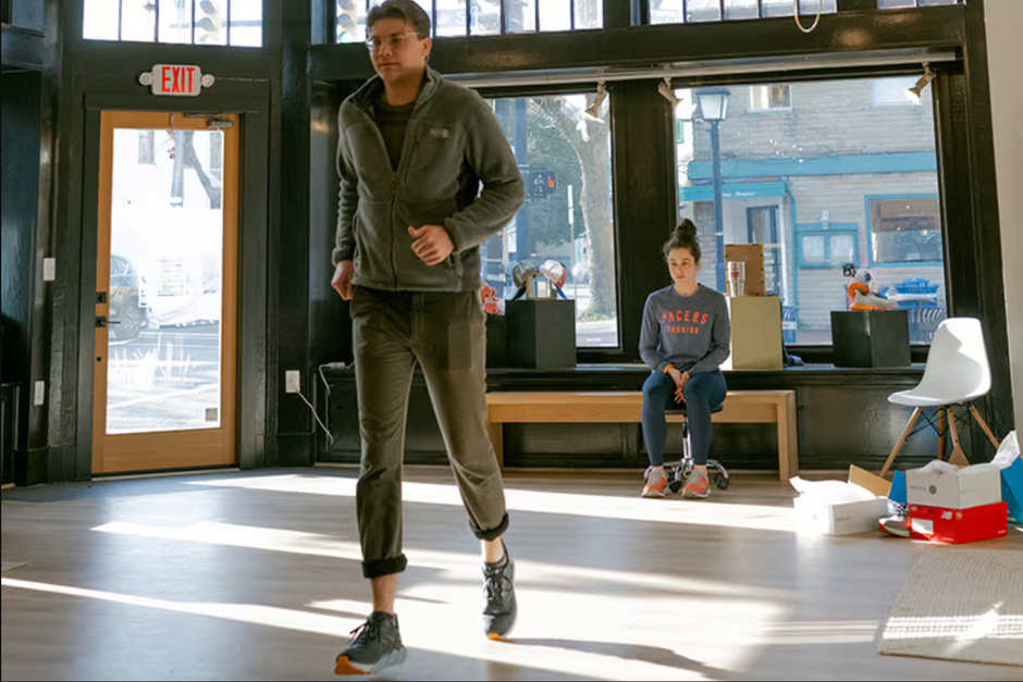 Woman assessing customer's running in new shoes